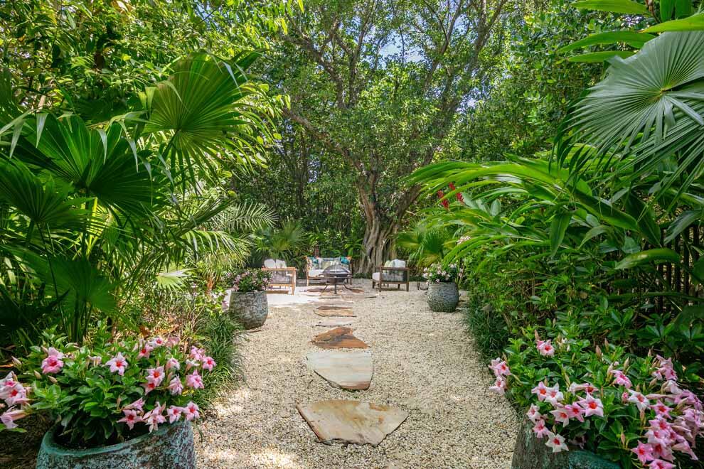 1230 North Ocean Boulevard Gulf Stream, FL 33483 - Photo 47 of 53 a view of a backyard with chair and potted plants