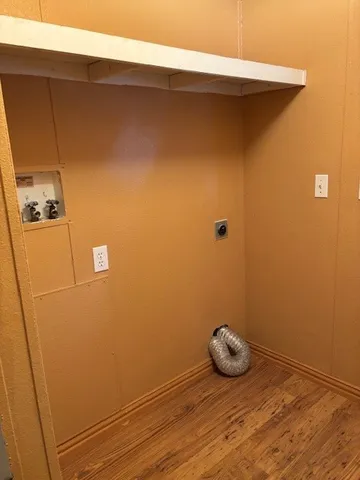 a view of a door and wooden floor