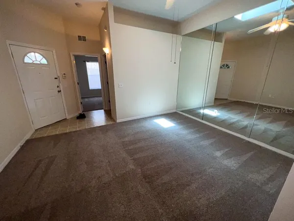 a view of a hallway with wooden shelves