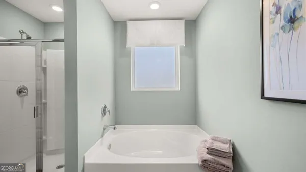 a bathroom with a bathtub and a shower