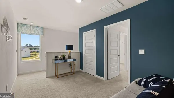 a view of a livingroom with couch and a workspace