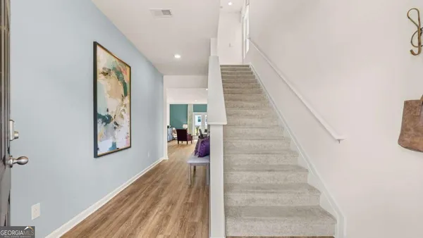 a view of entryway and hall with wooden floor