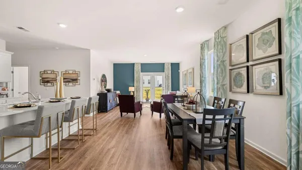 a view of a dining room with furniture window and wooden floor