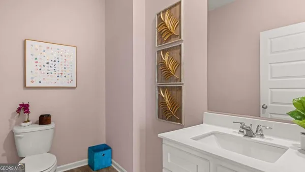 a bathroom with a toilet sink and mirror