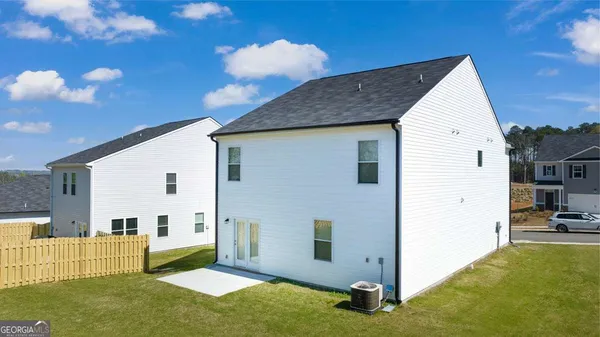 a view of backyard of house and car parked