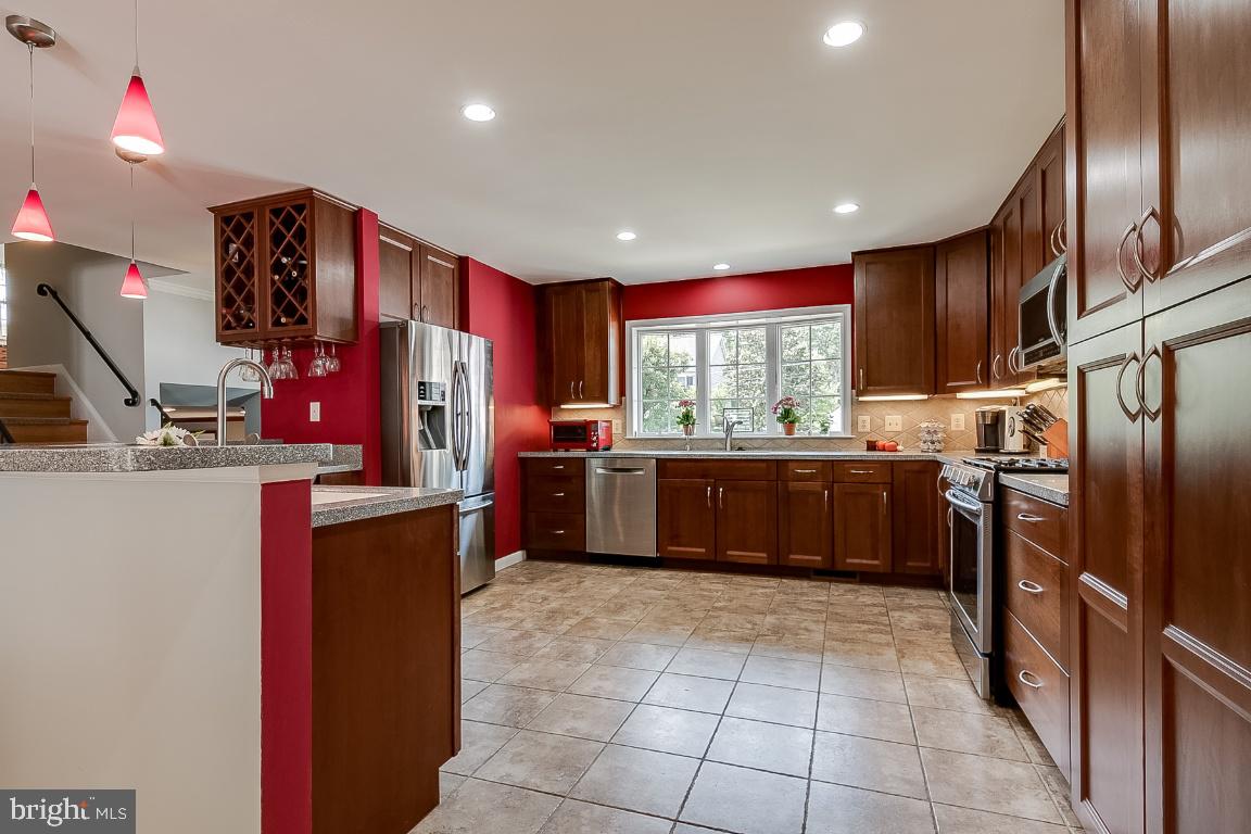 229 Manvell Road Southeast Vienna, VA 22180 - Photo 7 of 40 Tons of cabinet space in this rich wood kitchen!