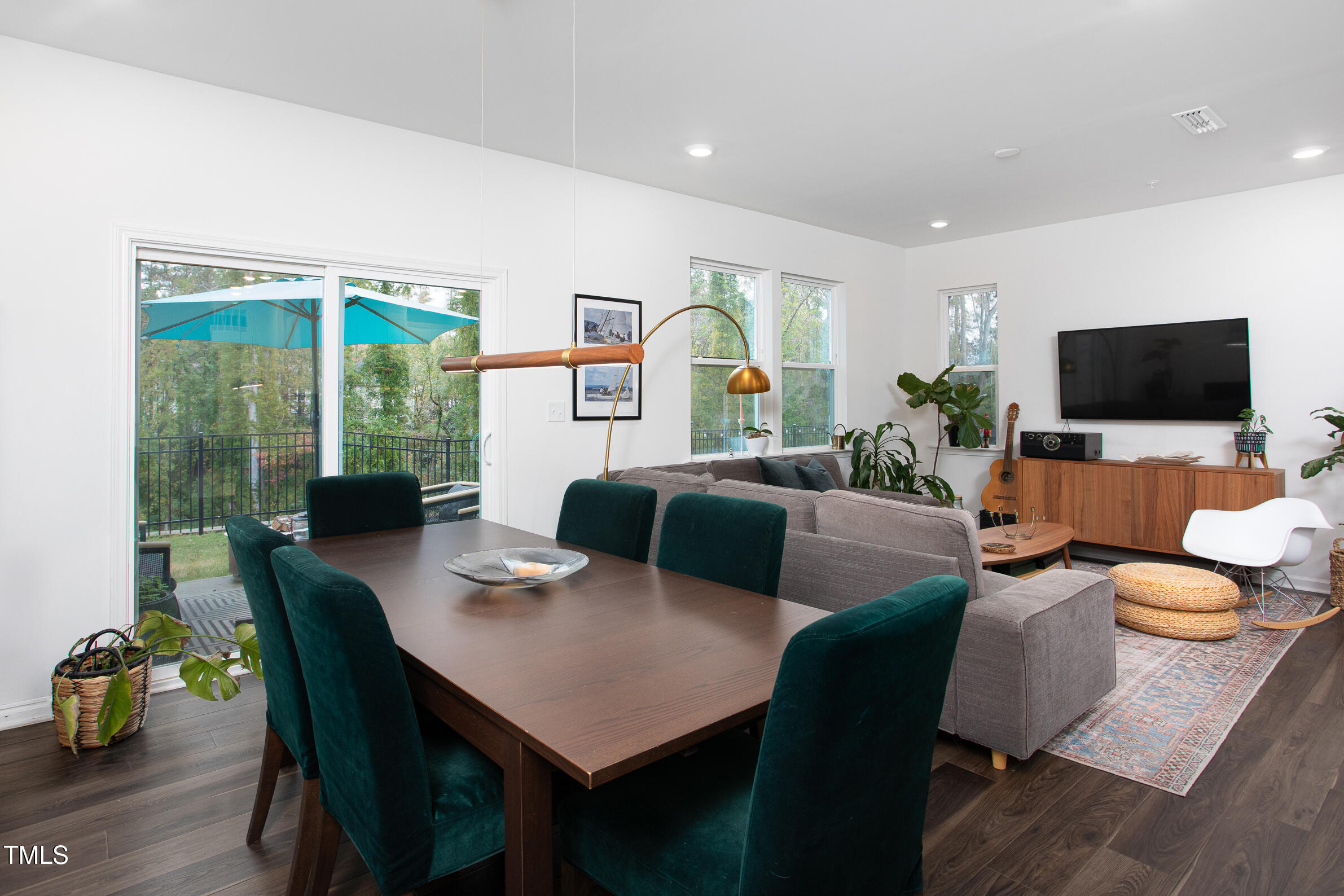 128 Rialto Street Chapel Hill, NC 27516 - Photo 13 of 44 a living room with furniture a large window and a flat screen tv