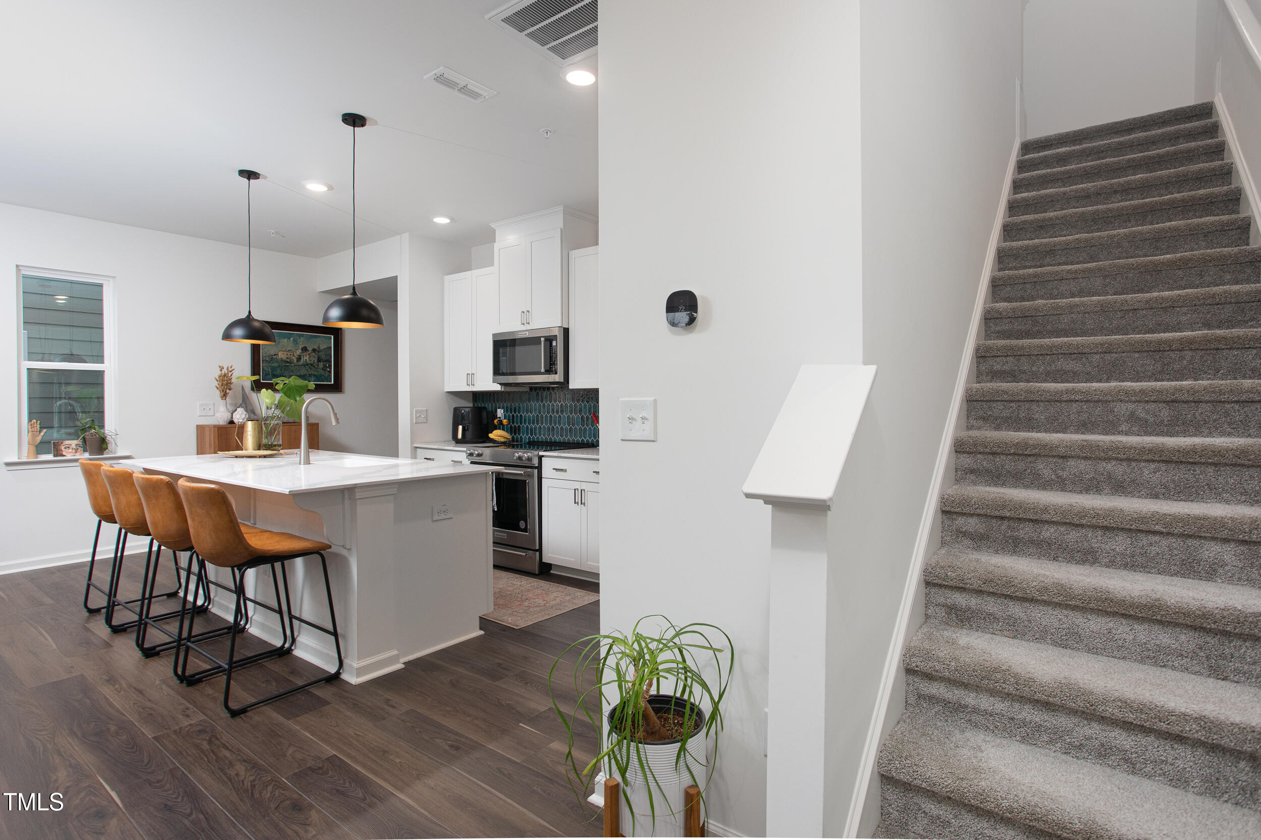 128 Rialto Street Chapel Hill, NC 27516 - Photo 22 of 44 a large white kitchen with lots of white cabinets appliances and furniture