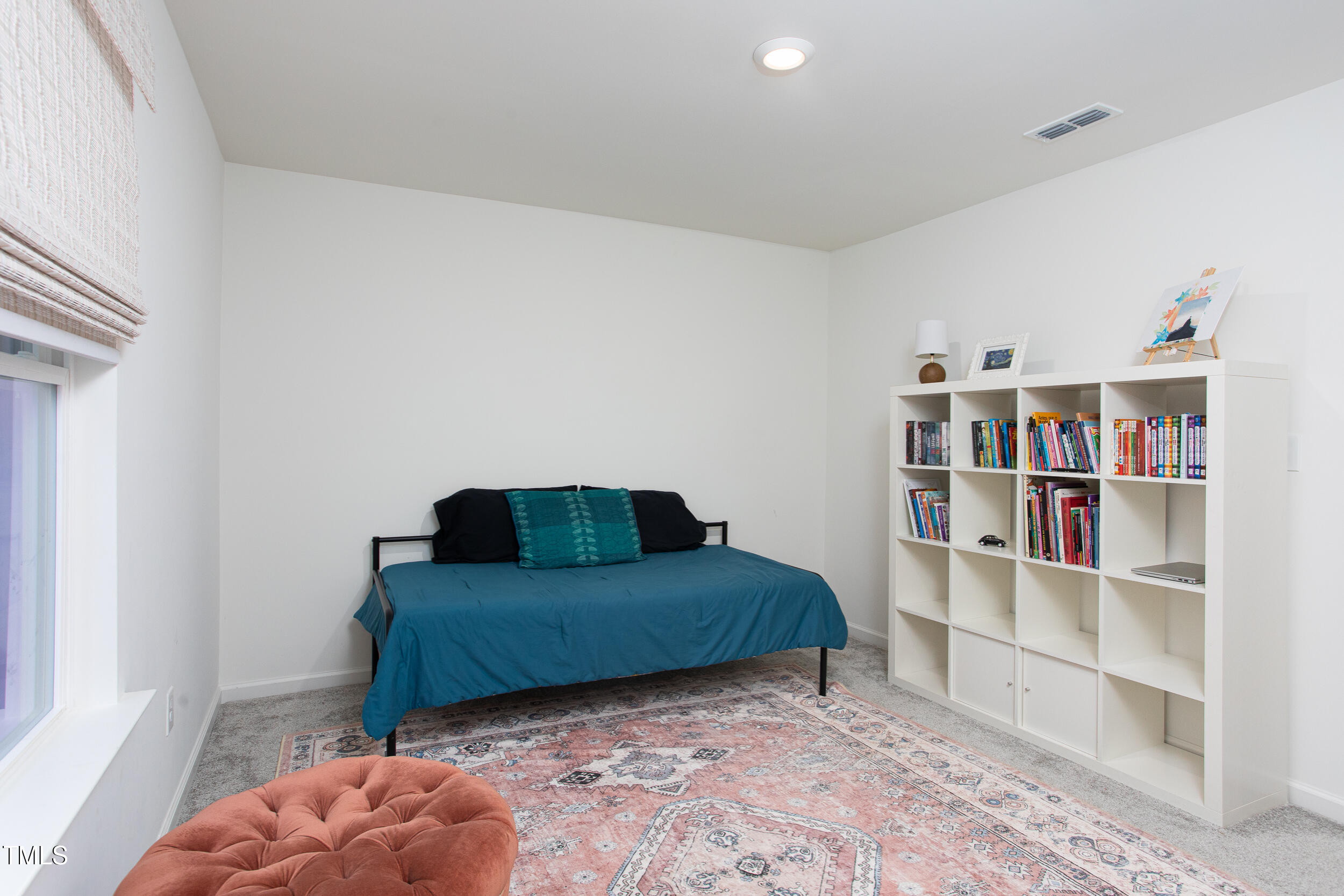128 Rialto Street Chapel Hill, NC 27516 - Photo 34 of 44 a living room with a book shelf and a window