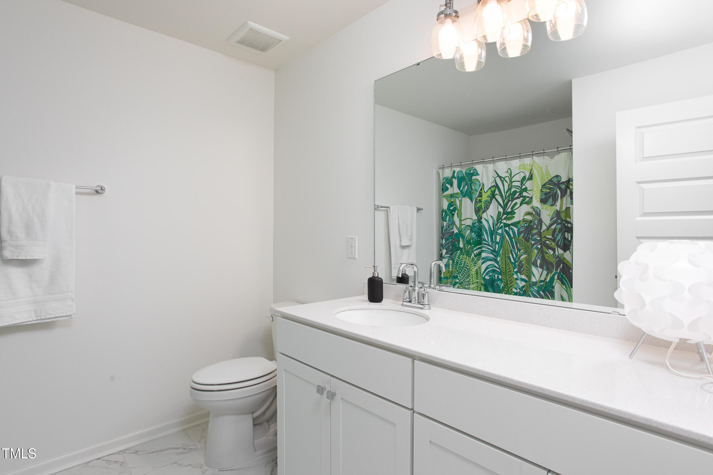 128 Rialto Street Chapel Hill, NC 27516 - Photo 38 of 44 a bathroom with a sink a toilet and a window