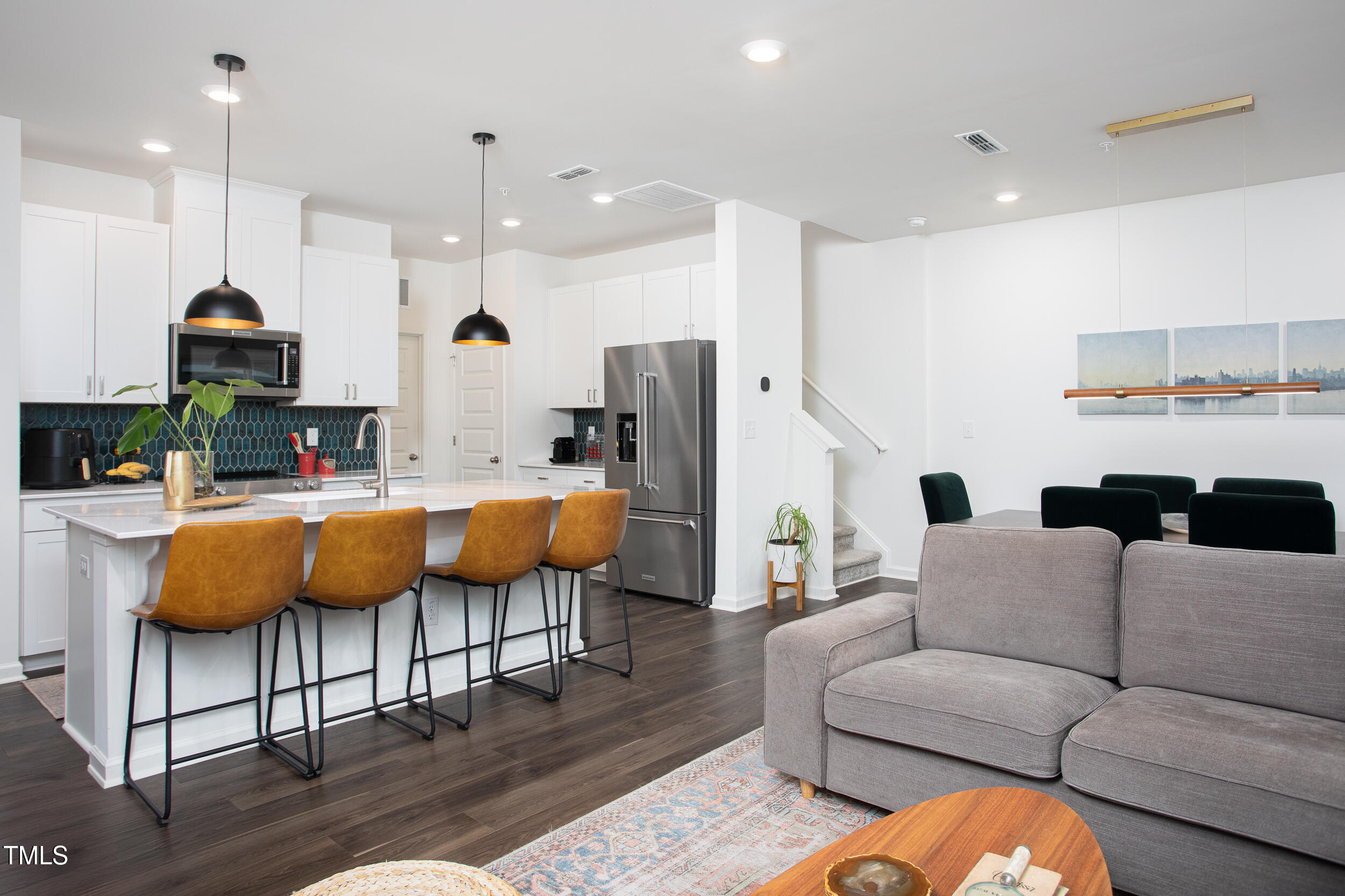 128 Rialto Street Chapel Hill, NC 27516 - Photo 6 of 44 a living room with stainless steel appliances kitchen island granite countertop a couch and a view of kitchen