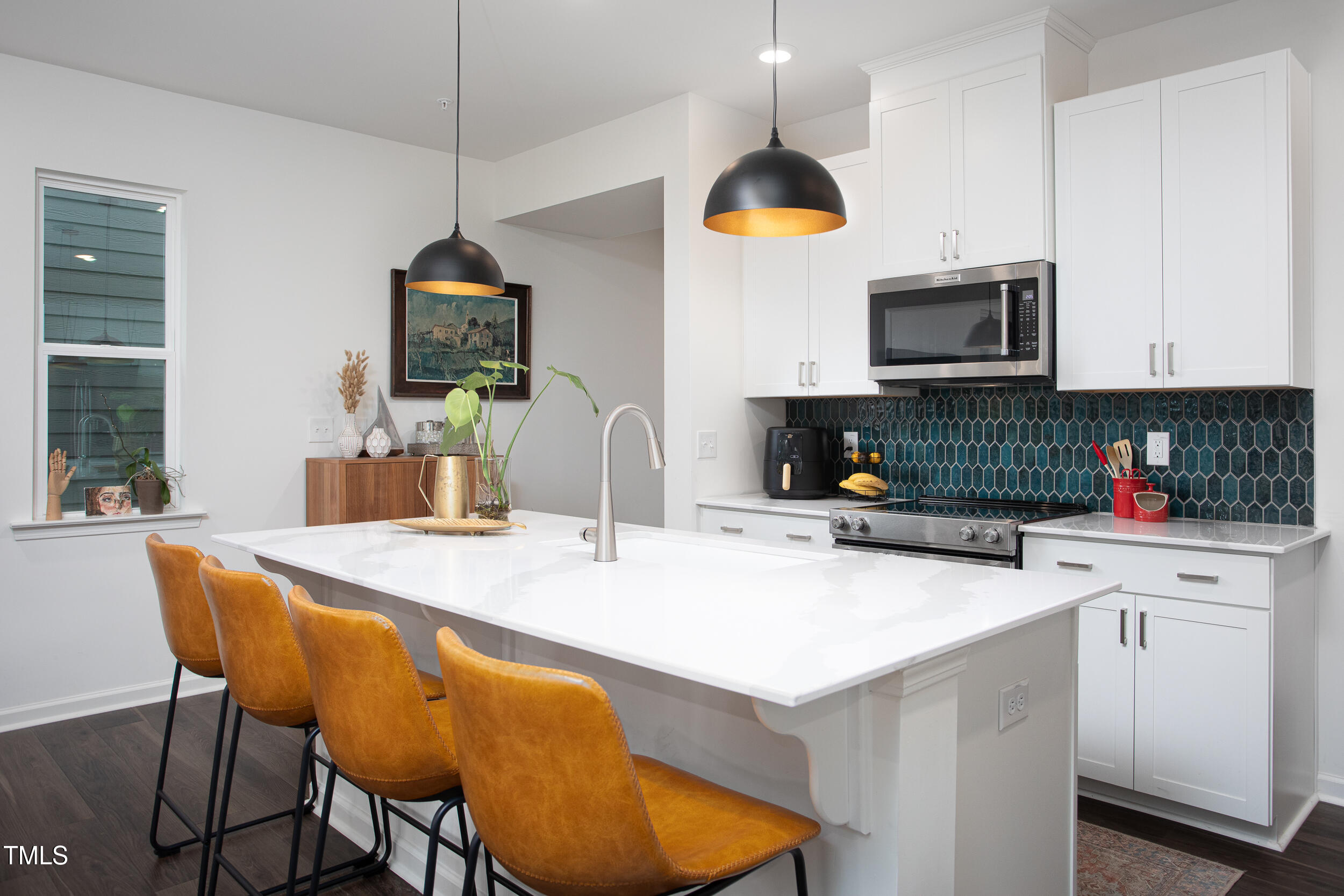 128 Rialto Street Chapel Hill, NC 27516 - Photo 7 of 44 a kitchen with a sink a stove and chairs
