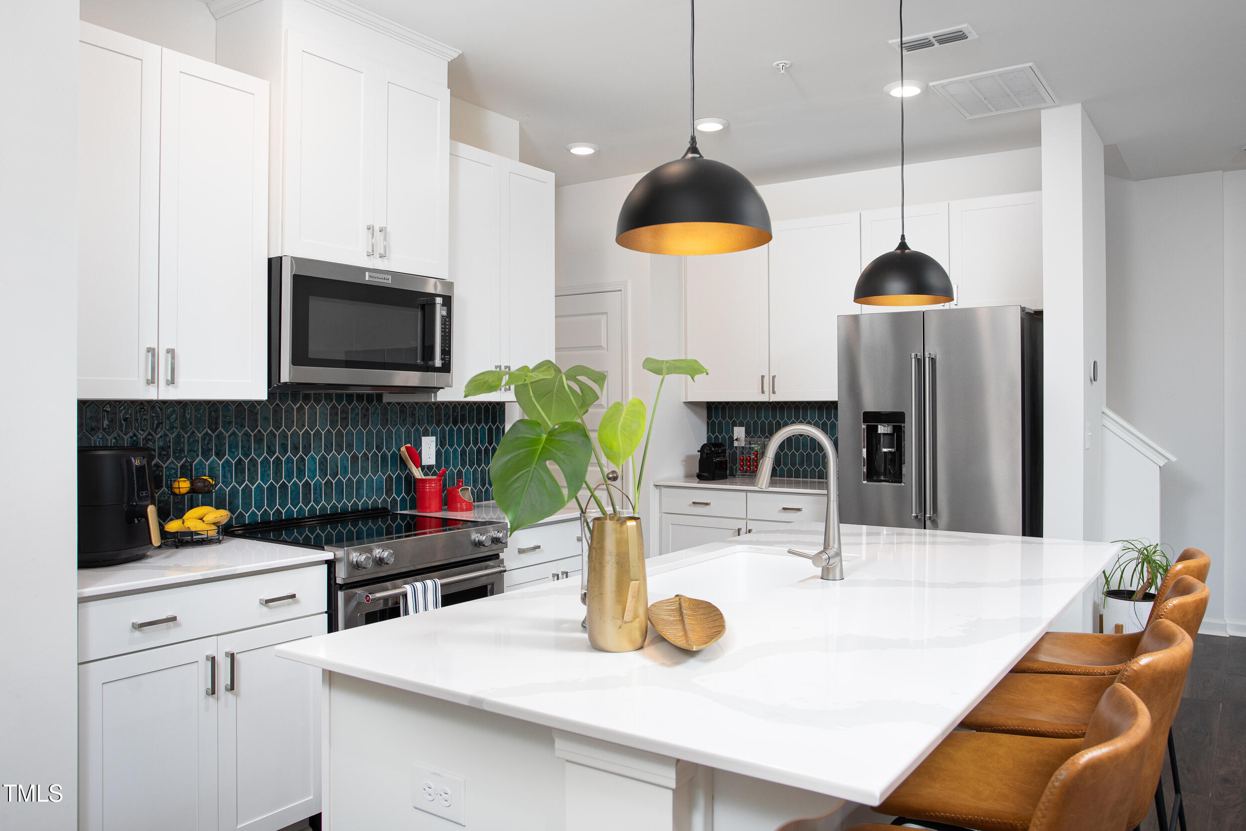128 Rialto Street Chapel Hill, NC 27516 - Photo 9 of 44 a kitchen with a sink a kitchen island a stove and a wooden floors