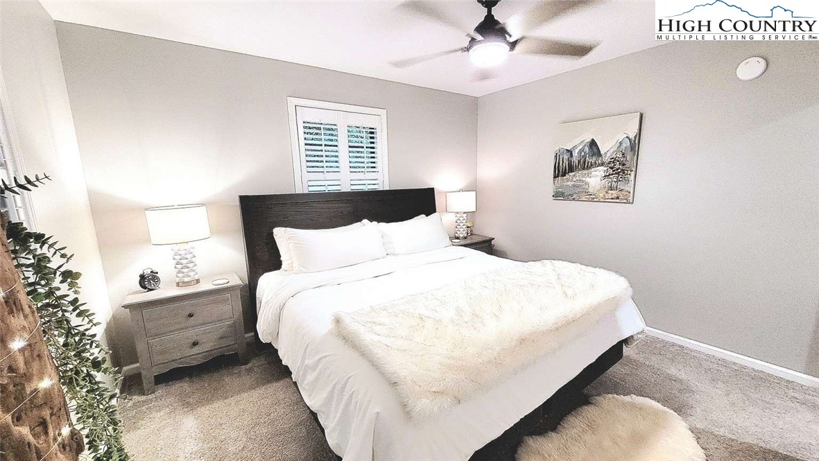 1157 Pine Ridge Road Beech Mountain, NC 28604 - Photo 12 of 25 a bed room with a bed and a chandelier