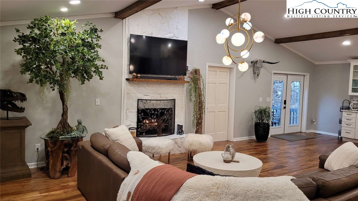 1157 Pine Ridge Road Beech Mountain, NC 28604 - Photo 15 of 25 a living room with furniture a flat screen tv and a fireplace