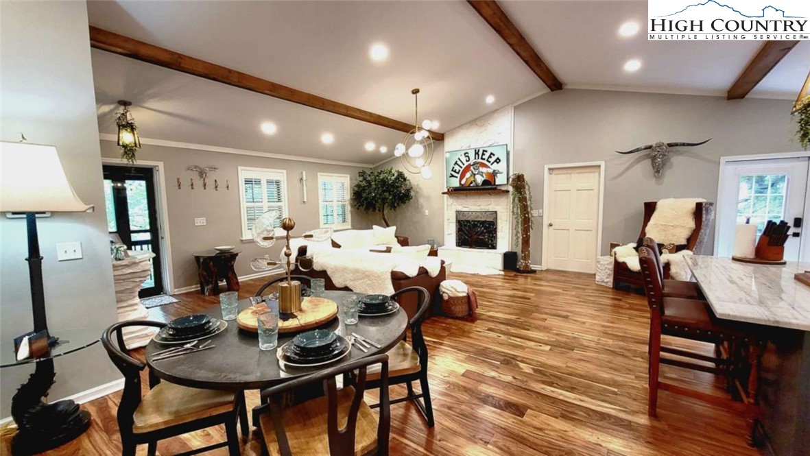 1157 Pine Ridge Road Beech Mountain, NC 28604 - Photo 5 of 25 a view of a dining room with furniture and wooden floor