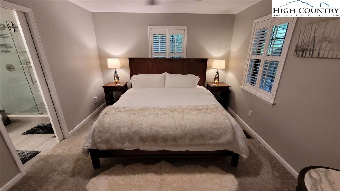 1157 Pine Ridge Road Beech Mountain, NC 28604 - Photo 8 of 25 a bed sitting in a bedroom next to a window