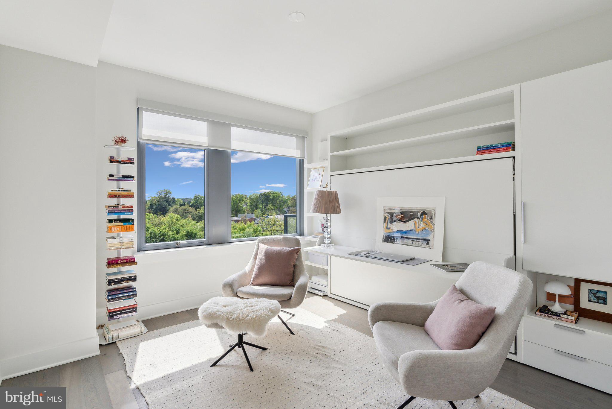4960 Fairmont Avenue, Unit 706 Bethesda, MD 20814 - Photo 12 of 26 a living room with furniture and a floor to ceiling window