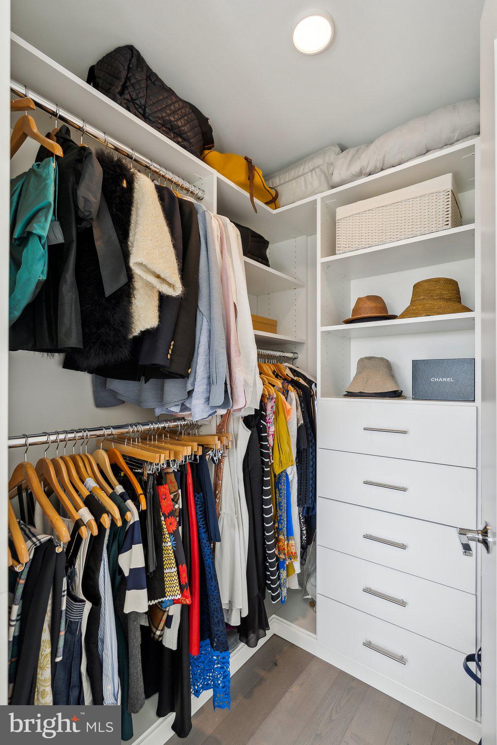 4960 Fairmont Avenue, Unit 706 Bethesda, MD 20814 - Photo 14 of 26 a view of walk in closet with clothes and shoes