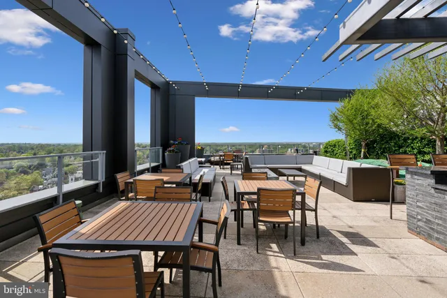 a view of a tables and chairs on the roof deck