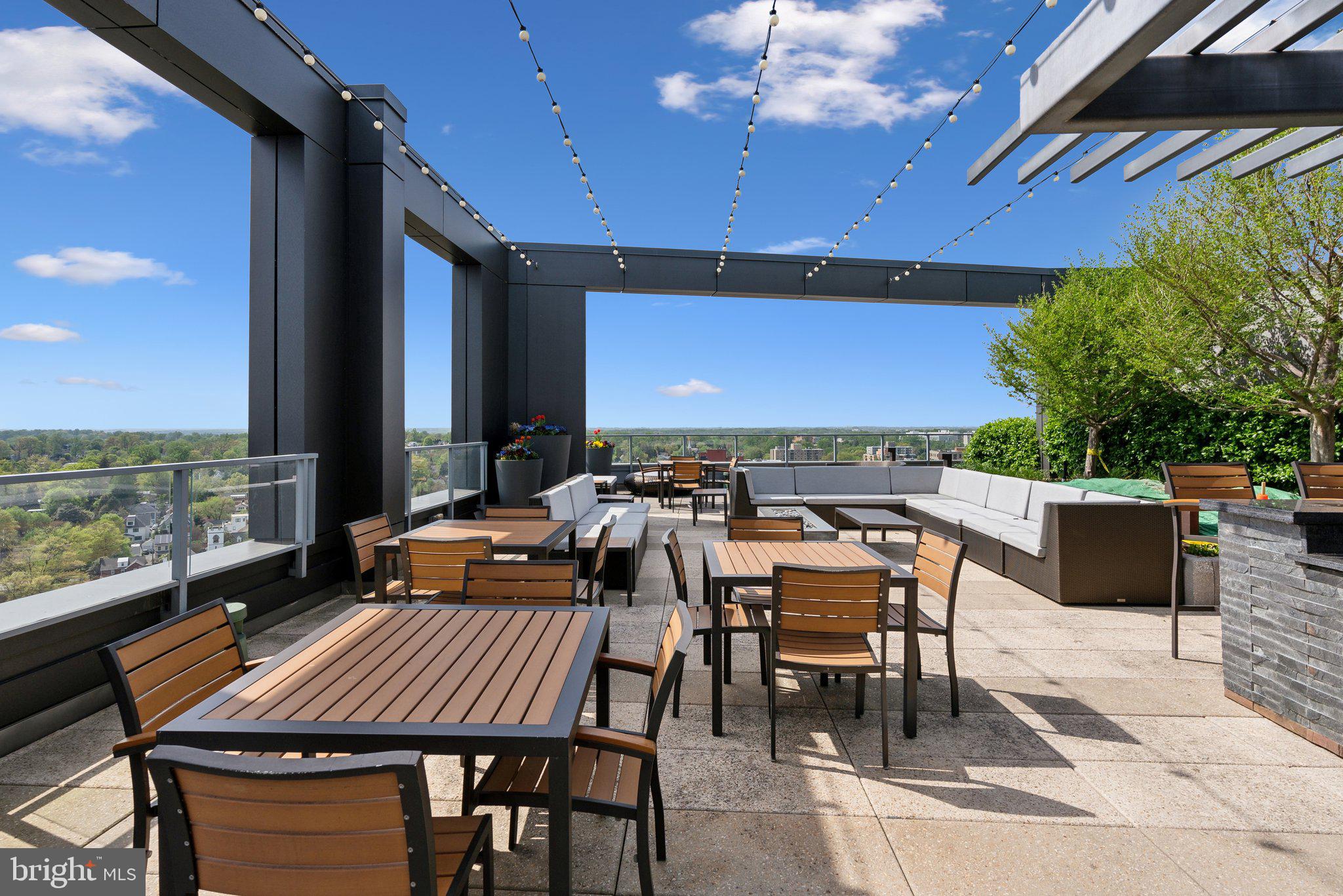 4960 Fairmont Avenue, Unit 706 Bethesda, MD 20814 - Photo 17 of 26 a view of a tables and chairs on the roof deck