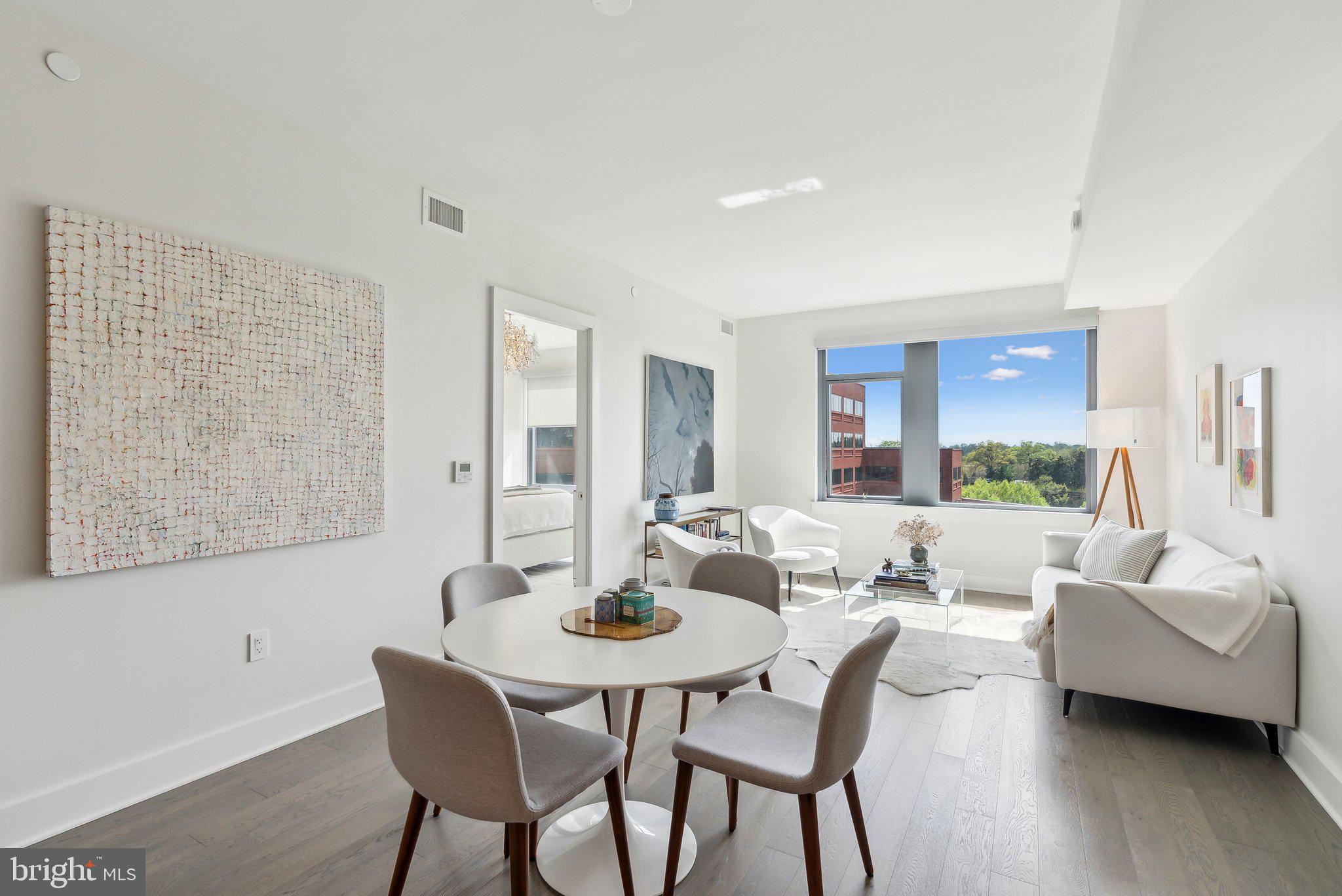 4960 Fairmont Avenue, Unit 706 Bethesda, MD 20814 - Photo 5 of 26 a view of a dining room with furniture and wooden floor