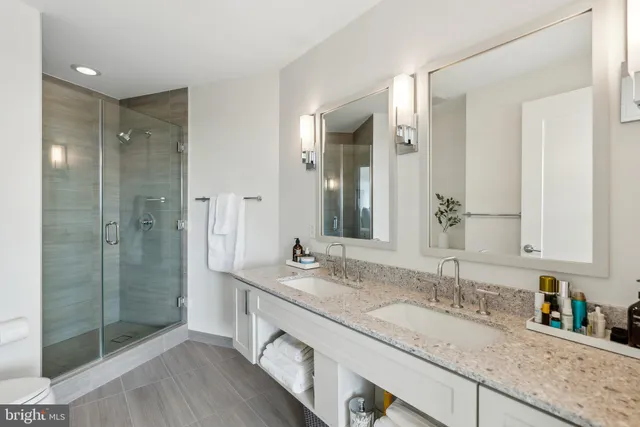 a bathroom with a granite countertop sink mirror and double