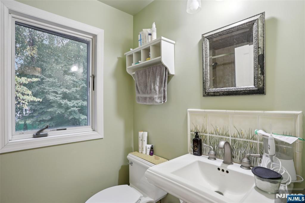 322 Marshall Street Ridgewood, NJ 07450 - Photo 21 of 32 a bathroom with a sink mirror and toilet