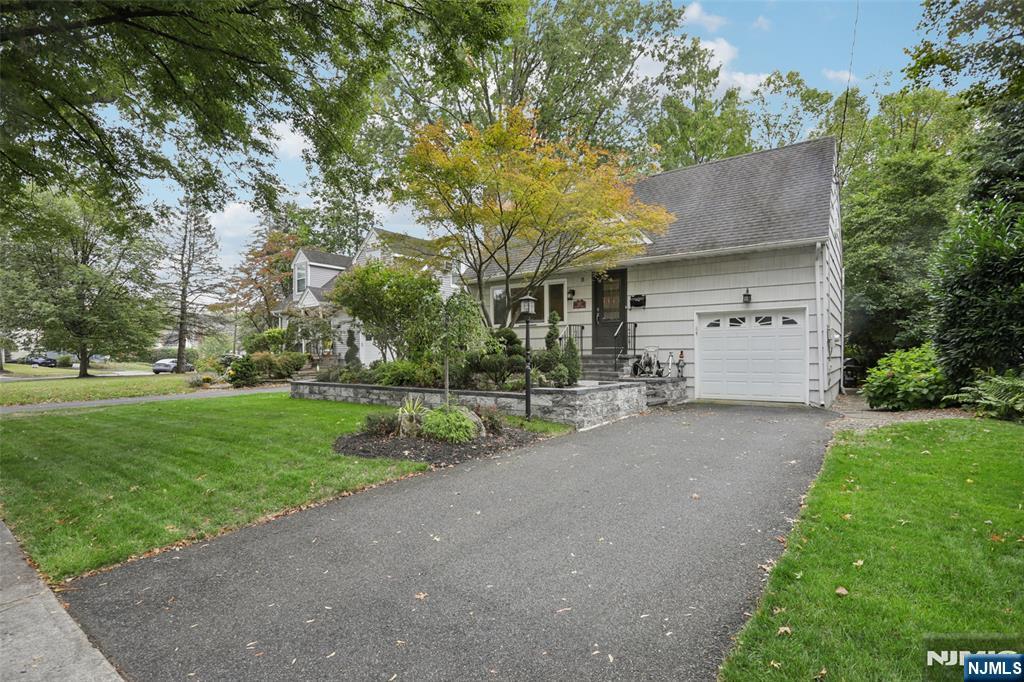 322 Marshall Street Ridgewood, NJ 07450 - Photo 3 of 32 a front view of a house with a yard and garage