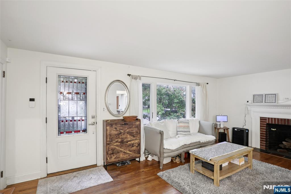 322 Marshall Street Ridgewood, NJ 07450 - Photo 6 of 32 a living room with furniture a fireplace and a large window
