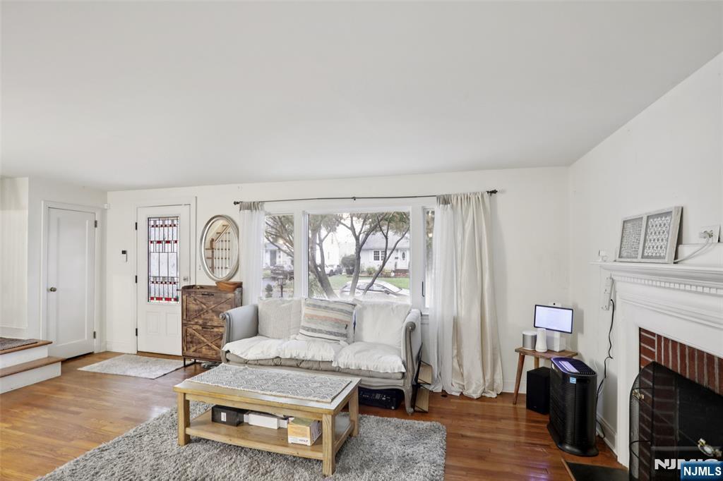 322 Marshall Street Ridgewood, NJ 07450 - Photo 7 of 32 a living room with furniture a fireplace and a window