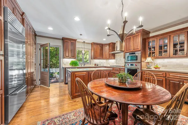 a kitchen with a dining table and chairs
