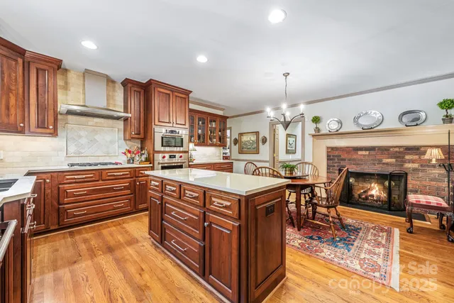 a kitchen with stainless steel appliances granite countertop a stove a sink and a refrigerator