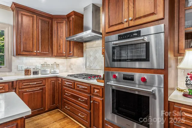 a kitchen with stainless steel appliances a stove a microwave and wooden cabinets