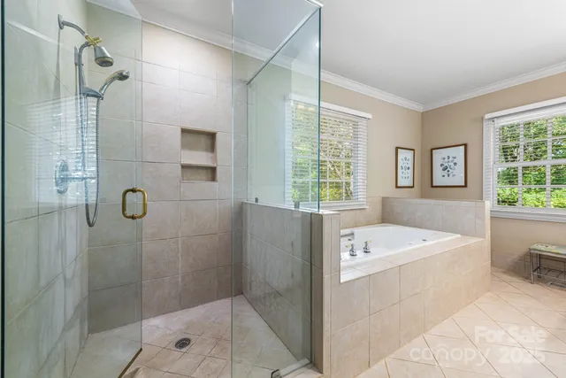 a bathroom with a tub sink and shower