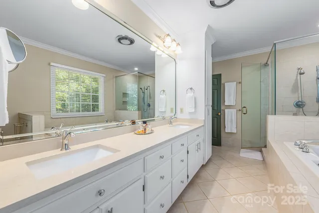 a bathroom with a double vanity sink mirror double and shower