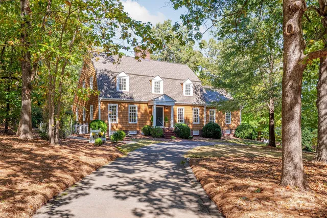 an aerial view of residential houses with outdoor space and swimming pool