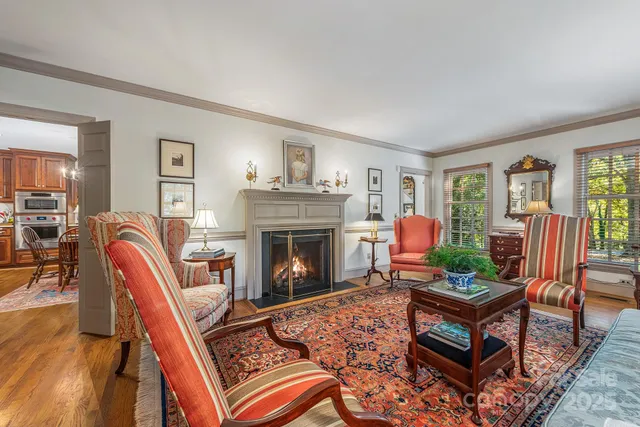 a living room with furniture a fireplace and a window