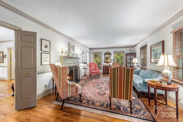 a living room with furniture a dining table and chairs with wooden floor