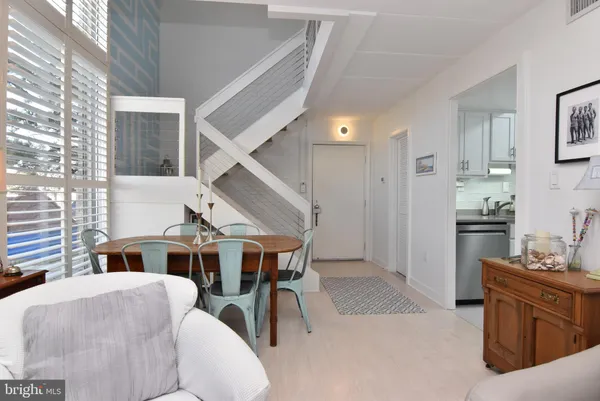 a kitchen with stainless steel appliances granite countertop white cabinets and a stove top oven