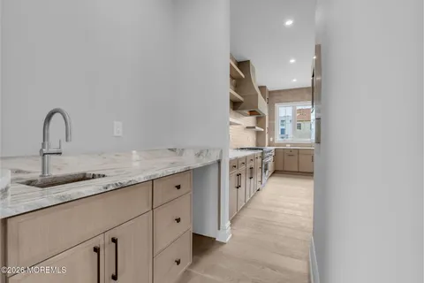 a kitchen with stainless steel appliances granite countertop a sink stove and cabinets