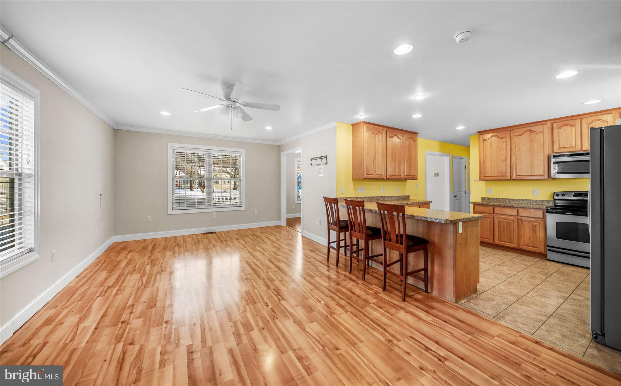 31536 White Street Laurel, DE 19956 - Photo 16 of 62 a open kitchen with granite countertop a stove top oven a sink dishwasher a dining table and chairs with wooden floor