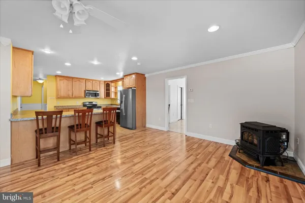 a kitchen with granite countertop stainless steel appliances a refrigerator stove top oven and sink