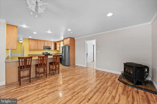 a kitchen with granite countertop stainless steel appliances a refrigerator stove top oven and sink