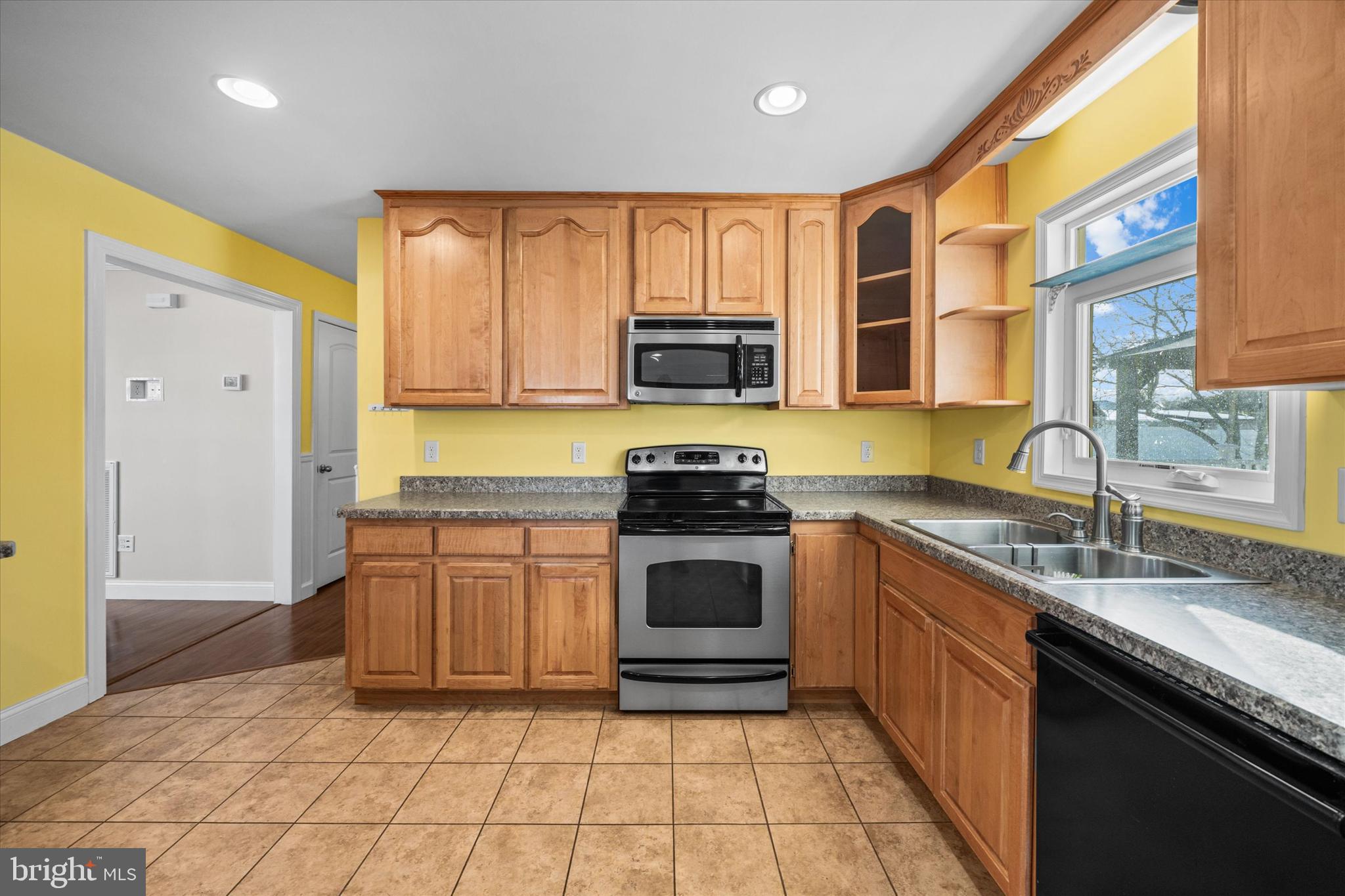 31536 White Street Laurel, DE 19956 - Photo 19 of 62 a kitchen with stainless steel appliances granite countertop a stove a sink and a microwave