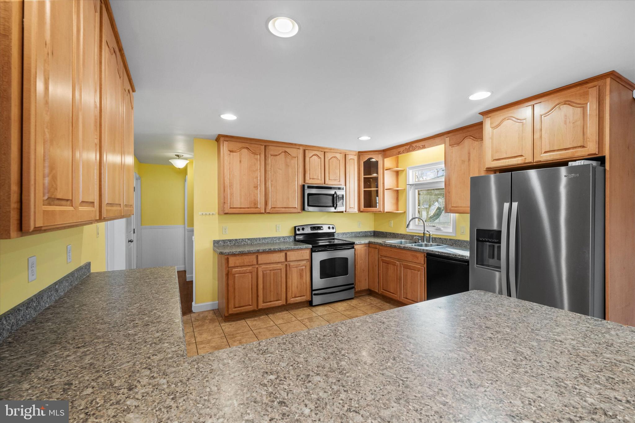 31536 White Street Laurel, DE 19956 - Photo 20 of 62 a kitchen with granite countertop stainless steel appliances a refrigerator stove top oven and sink