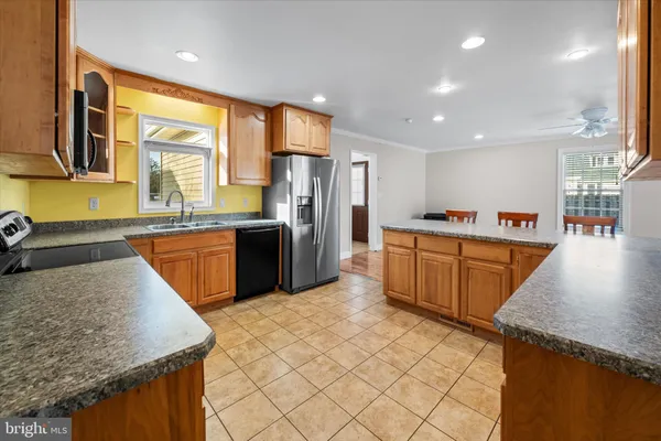 a kitchen with a refrigerator and a stove