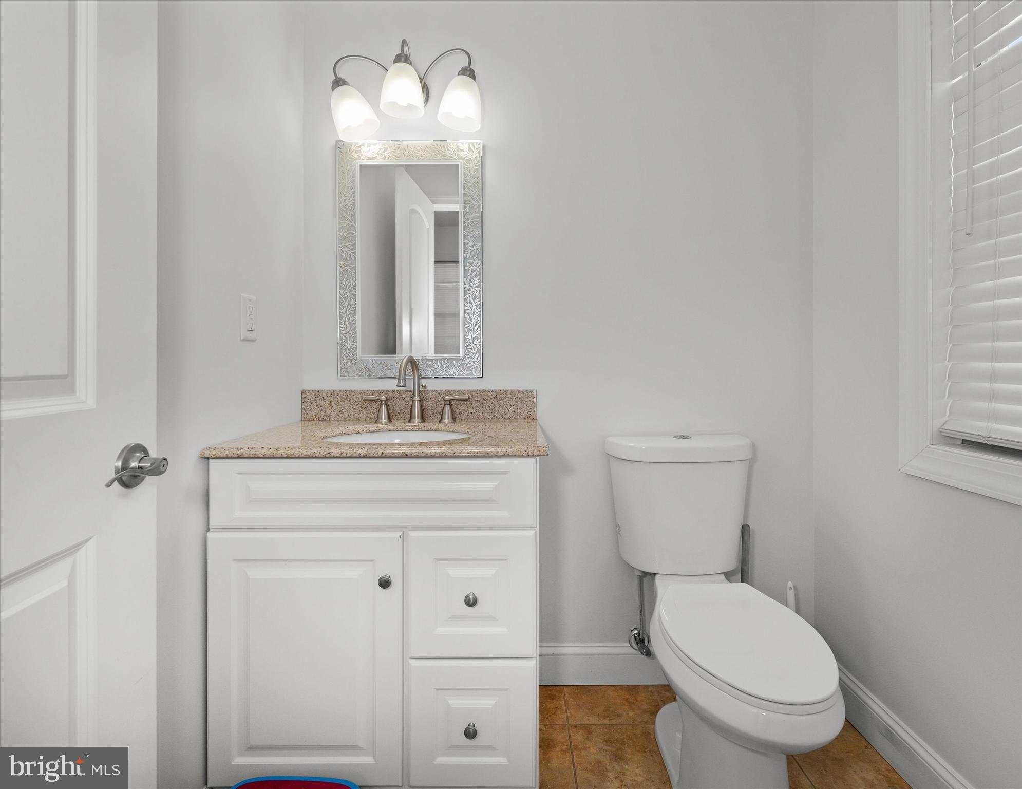 31536 White Street Laurel, DE 19956 - Photo 26 of 62 a bathroom with a toilet a sink and mirror