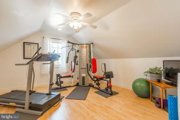 a bedroom with a bed and ceiling fan