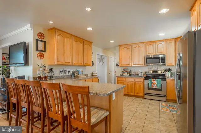 a large kitchen with granite countertop lots of counter space and windows
